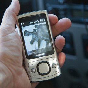 Randa Mirza, <em>The New Kids On The Block</em>, Armed bodyguards surround the headquarters of certain Islamic organizations and the homes of some Islamic leaders in Tripoli. (picture: Sheikh Dai al-Islam’s bodyguard's cell phone.) Photograph.