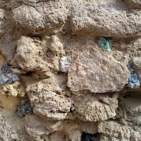 A wall in the city of Zwara, where holes have been filled with coloured plastic bags and then eroded by either wind or sun or eaten by goats, November 2011. Photograph courtesy and © Hadia Gana.