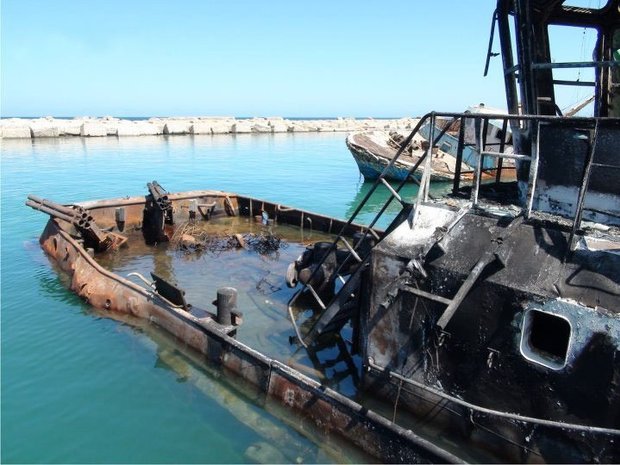 A bombarded boat in the city of Zwara. Photograph by Houda Elghali, October 2011. Courtesy and &copy; Houda Elghali. 