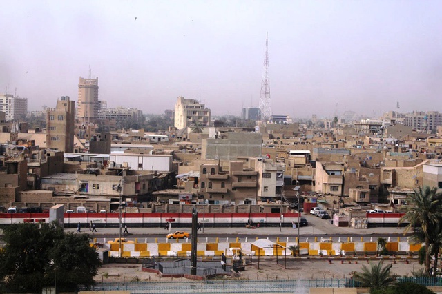 The Iraqi flag along a 300-metre wall on Jumhurriya Street, facing the walls of the Baghdad Mayoralty compound, in Rusafa.